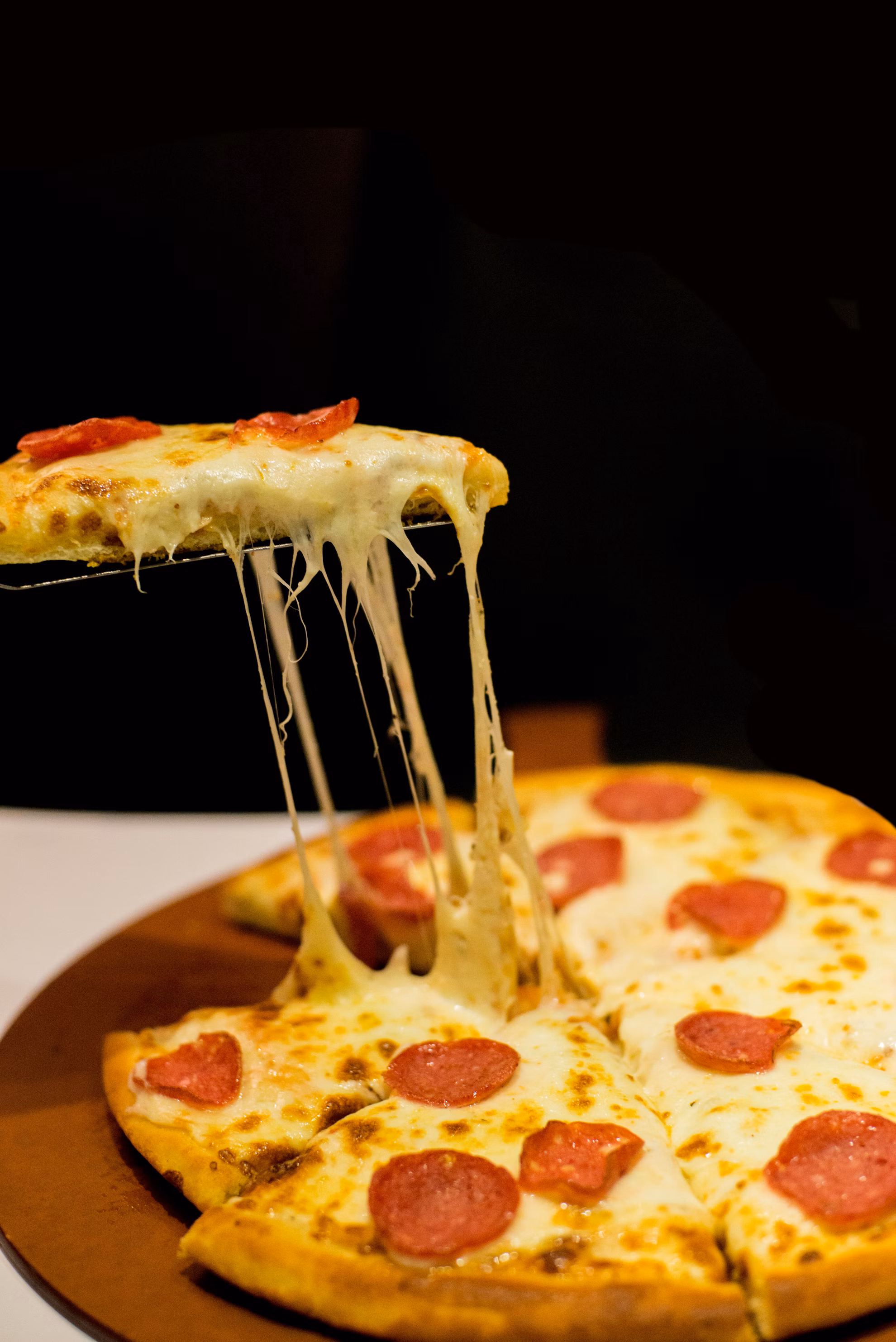 Person cutting pizza